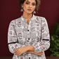 White Cotton Shirt with Warli Print, Mandarin Collar & Crochet Trimmed Full Sleeves — styled view