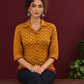 Mustard Bandhani Print Rayon Shirt with Contrast Maroon Hemline and Cuff Detailing — seated
