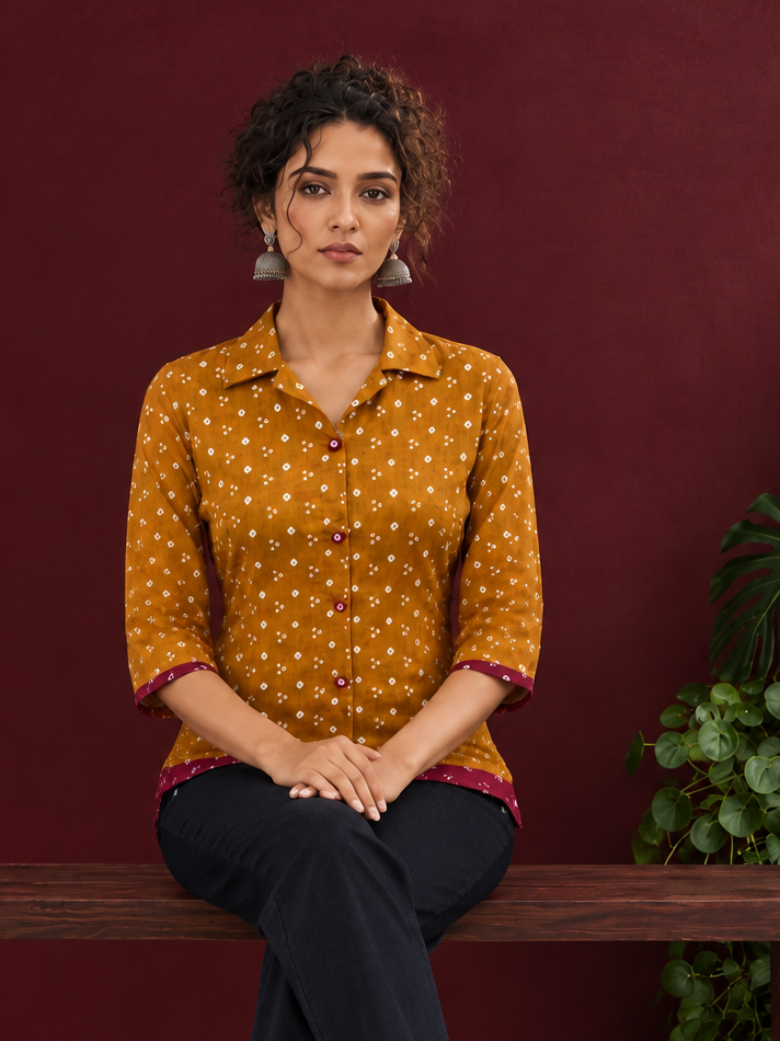 Mustard Bandhani Print Rayon Shirt with Contrast Maroon Hemline and Cuff Detailing — seated