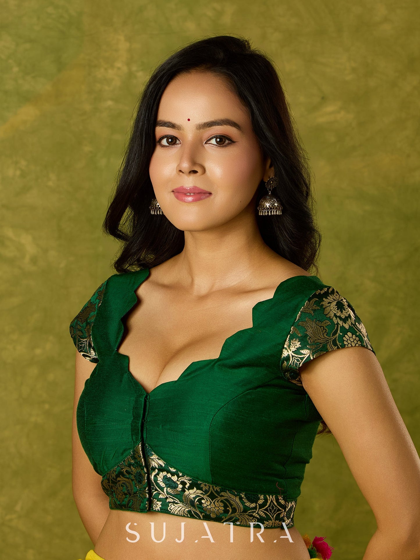 Festive dark green cap sleeve blouse with rich Banarasi combination