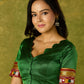 Elegant green khun blouse exuding festive flair and tradition.