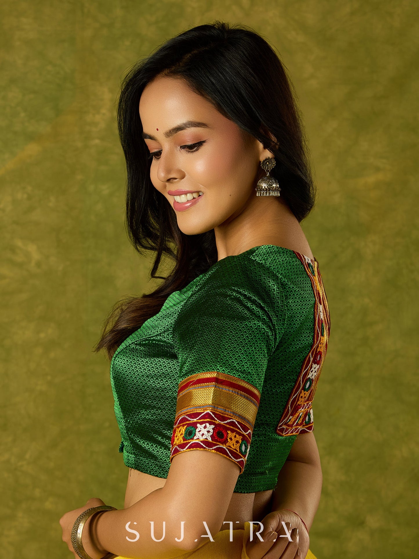 Elegant green khun blouse exuding festive flair and tradition.