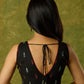Beautiful black cotton sleeveless blouse with elegant fabric combination .
