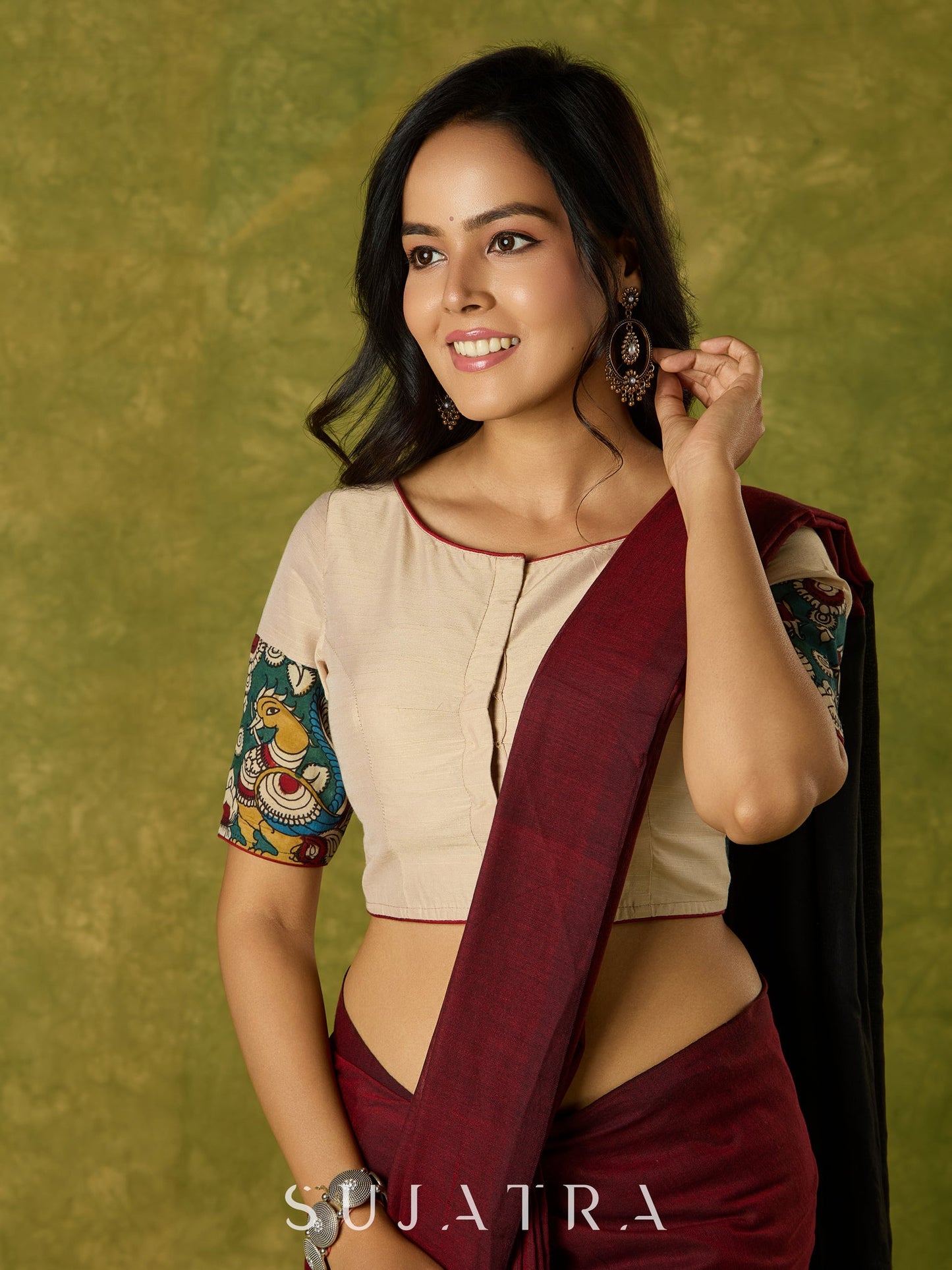 Beige cotton silk blouse beautifully blended with artistic kalamkari detailing.