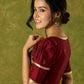 Exquisite maroon butti cotton silk blouse with rich festive appeal.