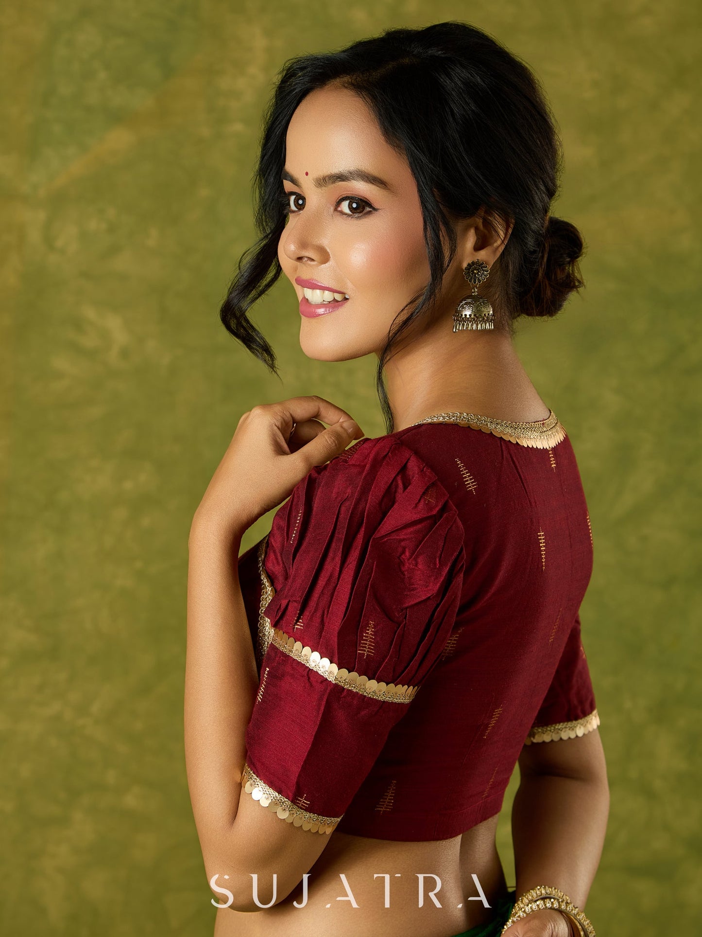 Exquisite maroon butti cotton silk blouse with rich festive appeal.