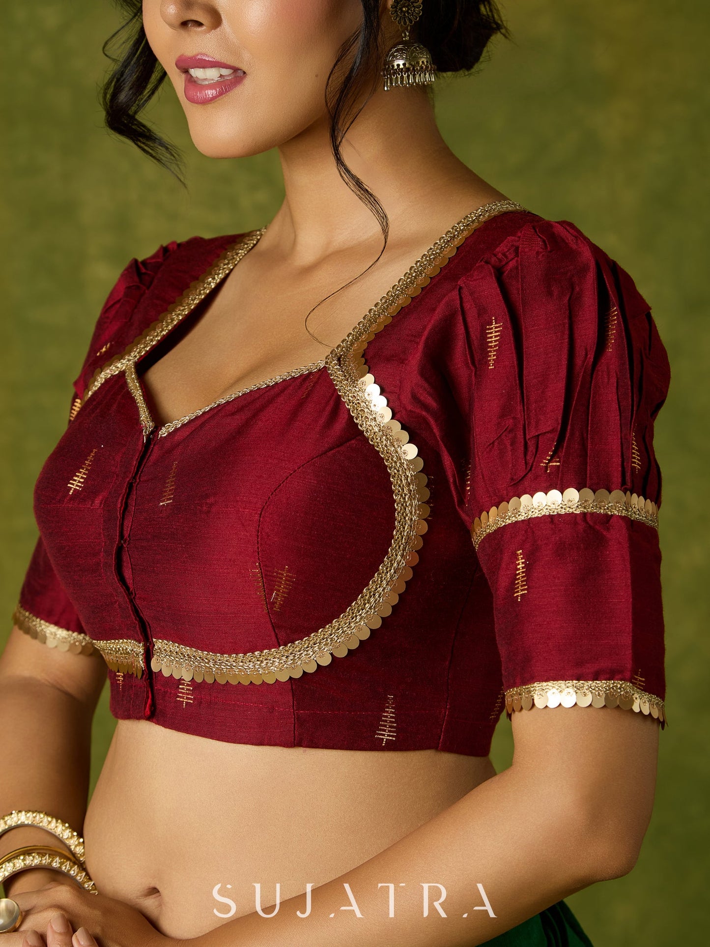 Exquisite maroon butti cotton silk blouse with rich festive appeal.