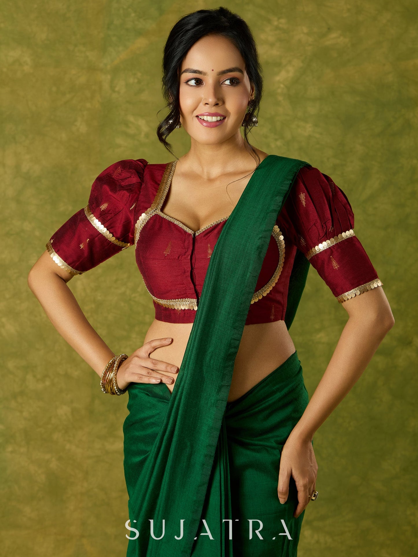 Exquisite maroon butti cotton silk blouse with rich festive appeal.