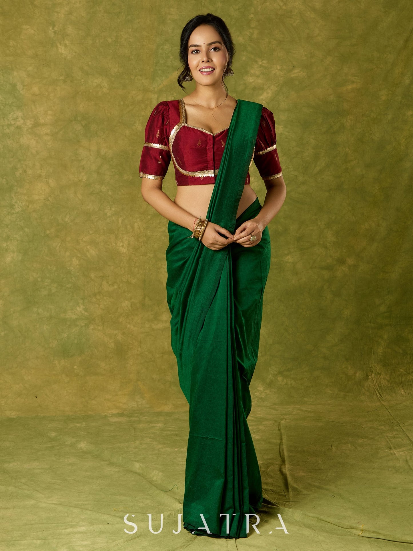 Exquisite maroon butti cotton silk blouse with rich festive appeal.