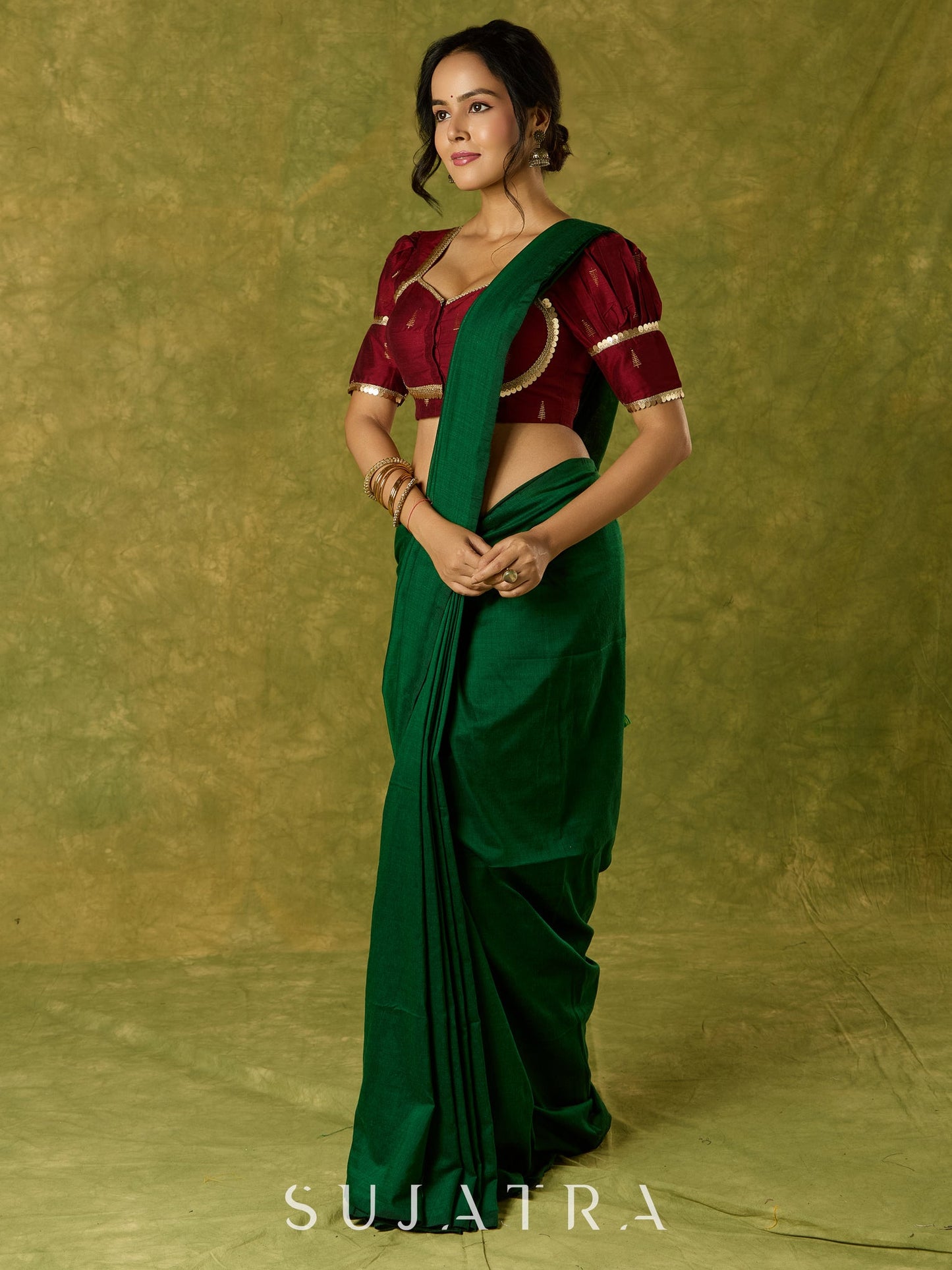 Exquisite maroon butti cotton silk blouse with rich festive appeal.