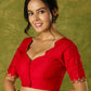 Festive hand embroidered red cotton silk blouse with elegant scallop detailing.