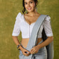 Elegant white blouse with chikankari, moti embroidery, and lace.
