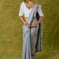 Elegant white blouse with chikankari, moti embroidery, and lace.