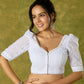 Elegant white blouse with chikankari, moti embroidery, and lace.