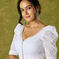 Elegant white blouse with chikankari, moti embroidery, and lace.