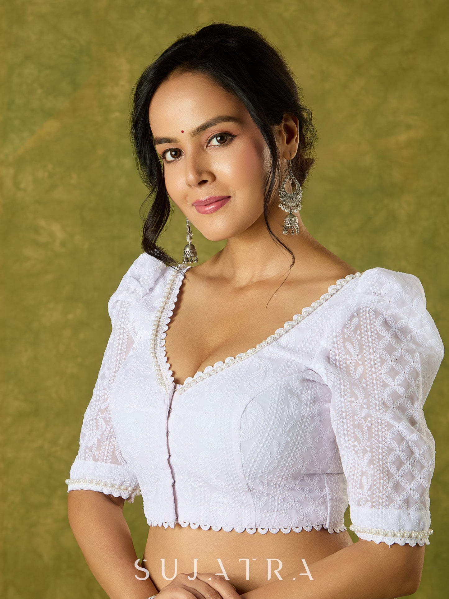 Elegant white blouse with chikankari, moti embroidery, and lace.