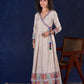 Artisanal Beige Handloom Cotton Angarkha Long Gown with Madhubani Border Embellished Neckline, Sleeve & Flare, with Vibrant Statement Tassels