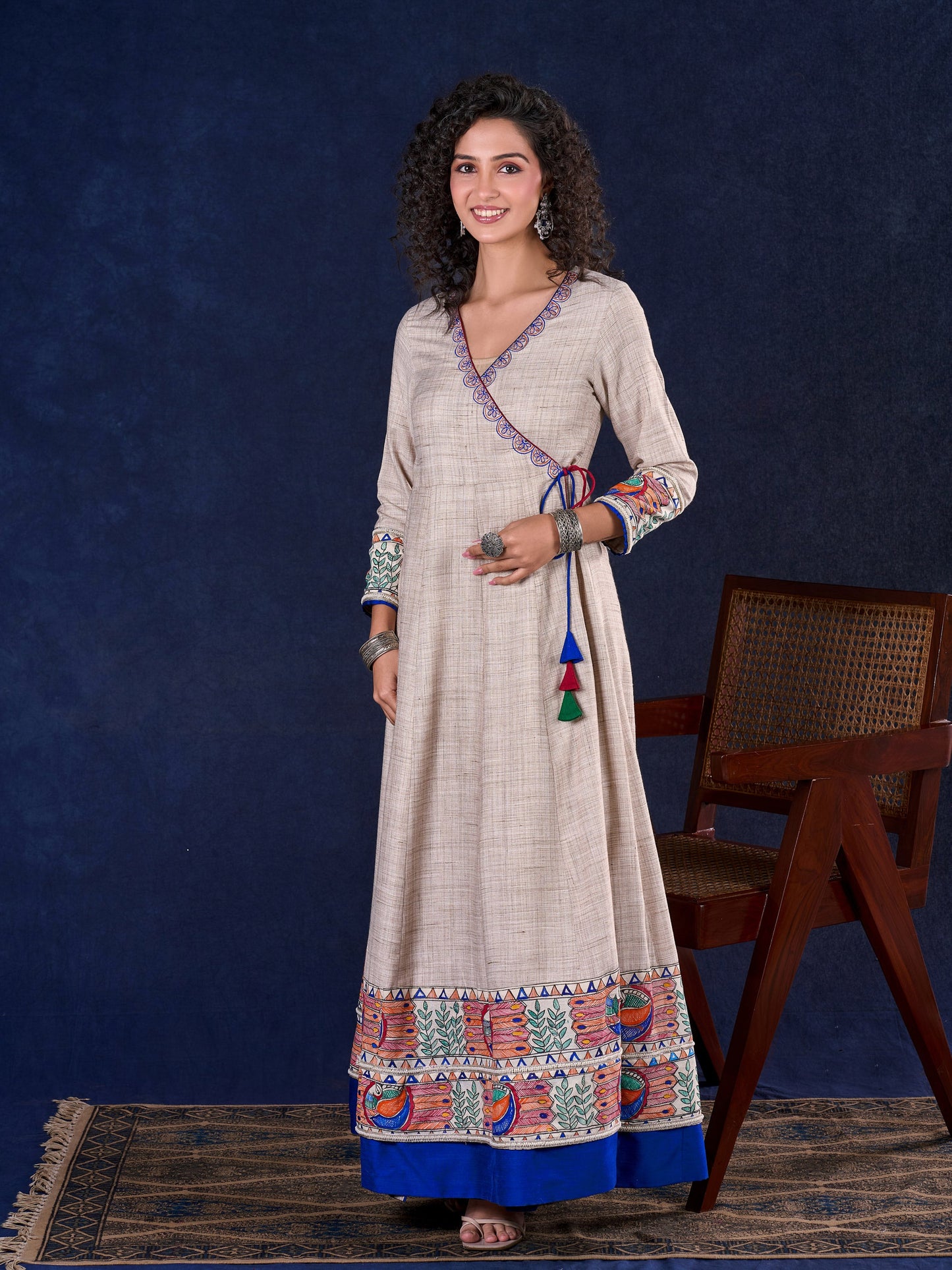 Artisanal Beige Handloom Cotton Angarkha Long Gown with Madhubani Border Embellished Neckline, Sleeve & Flare, with Vibrant Statement Tassels