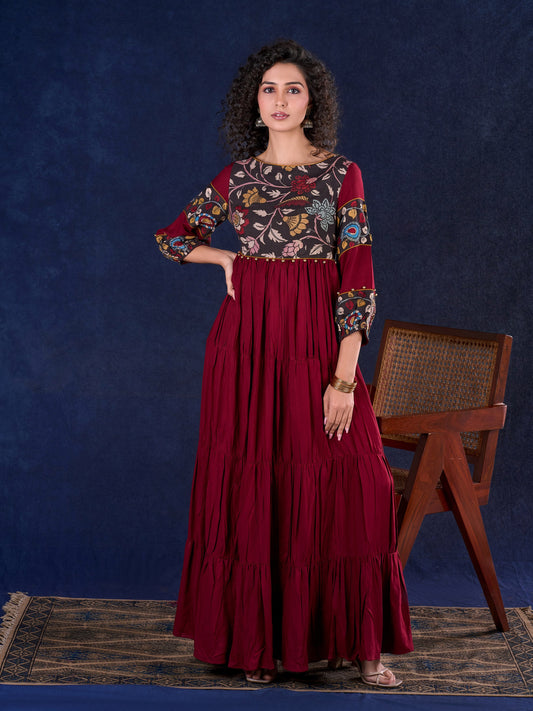 Timeless Maroon Rayon Layered Gown with Gathers and Hand Painted Kalamkari Accents featuring Puffy Sleeves and Delicate Golden Accents