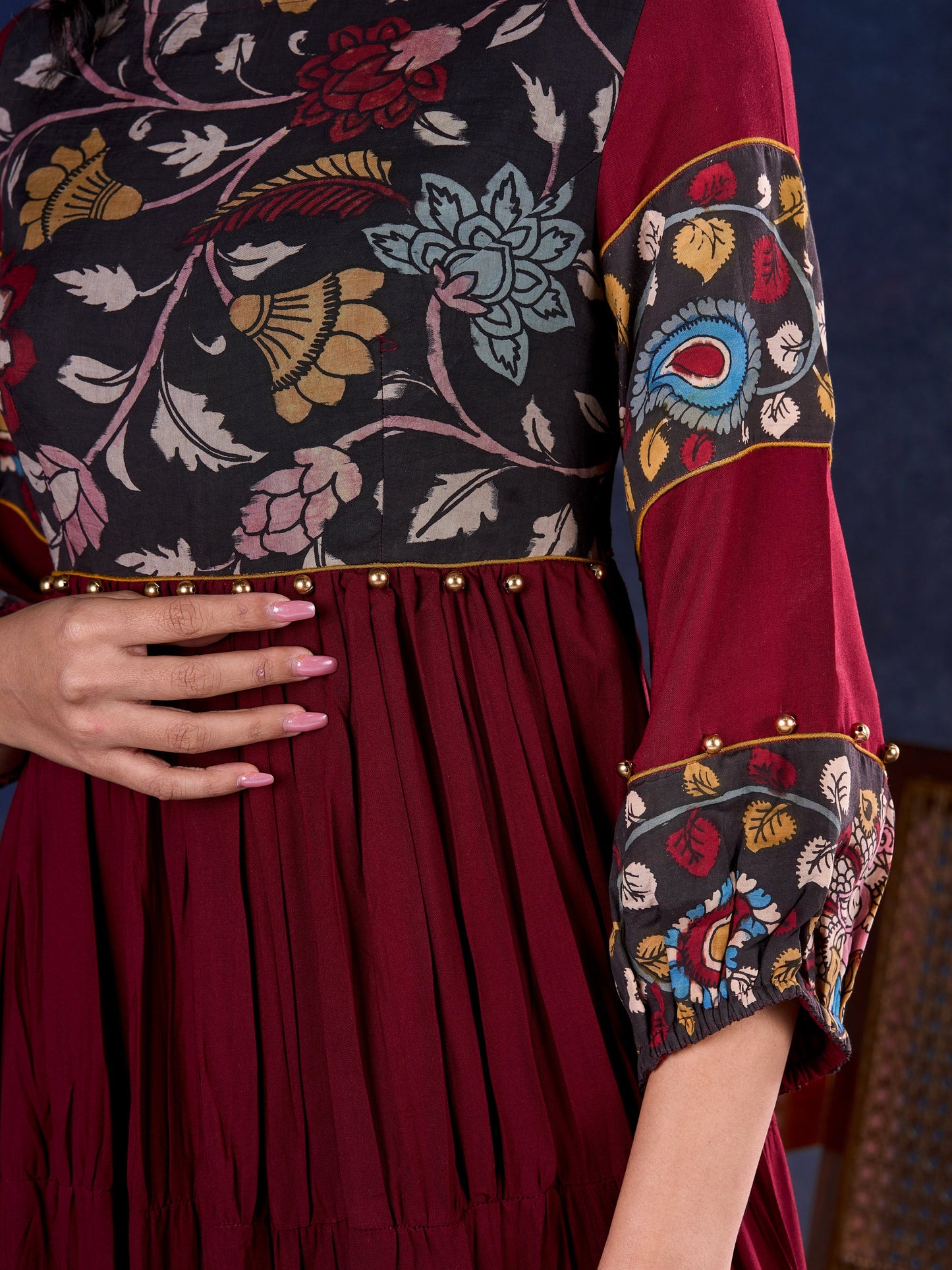 Timeless Maroon Rayon Layered Gown with Gathers and Hand Painted Kalamkari Accents featuring Puffy Sleeves and Delicate Golden Accents