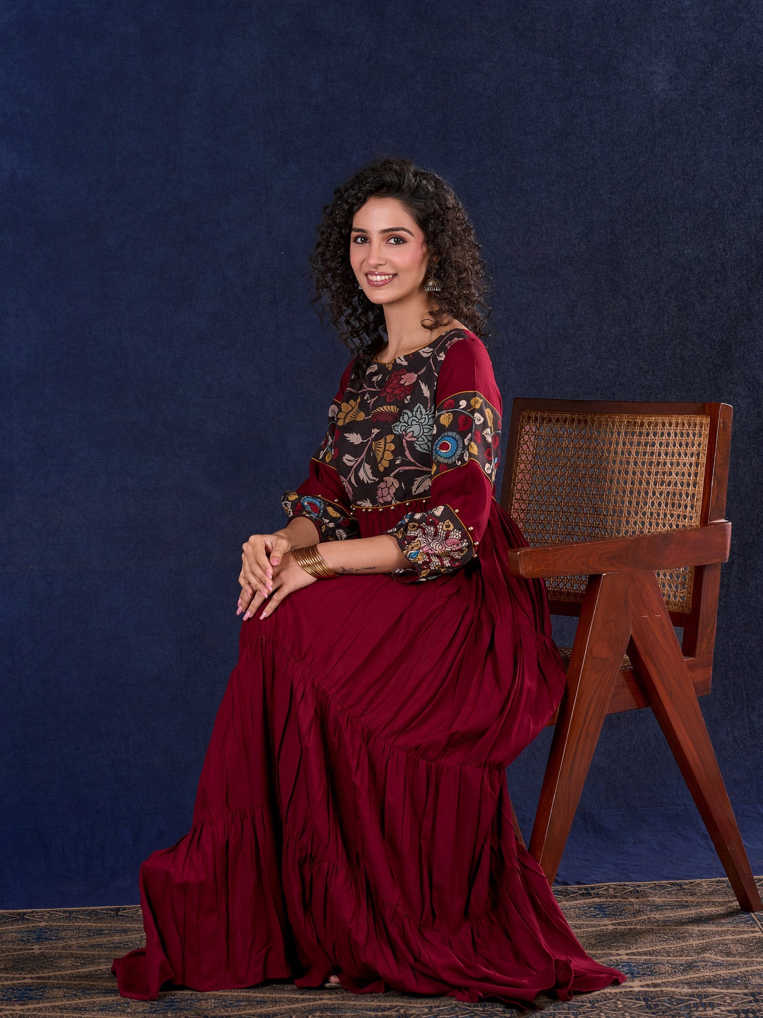 Timeless Maroon Rayon Layered Gown with Gathers and Hand Painted Kalamkari Accents featuring Puffy Sleeves and Delicate Golden Accents