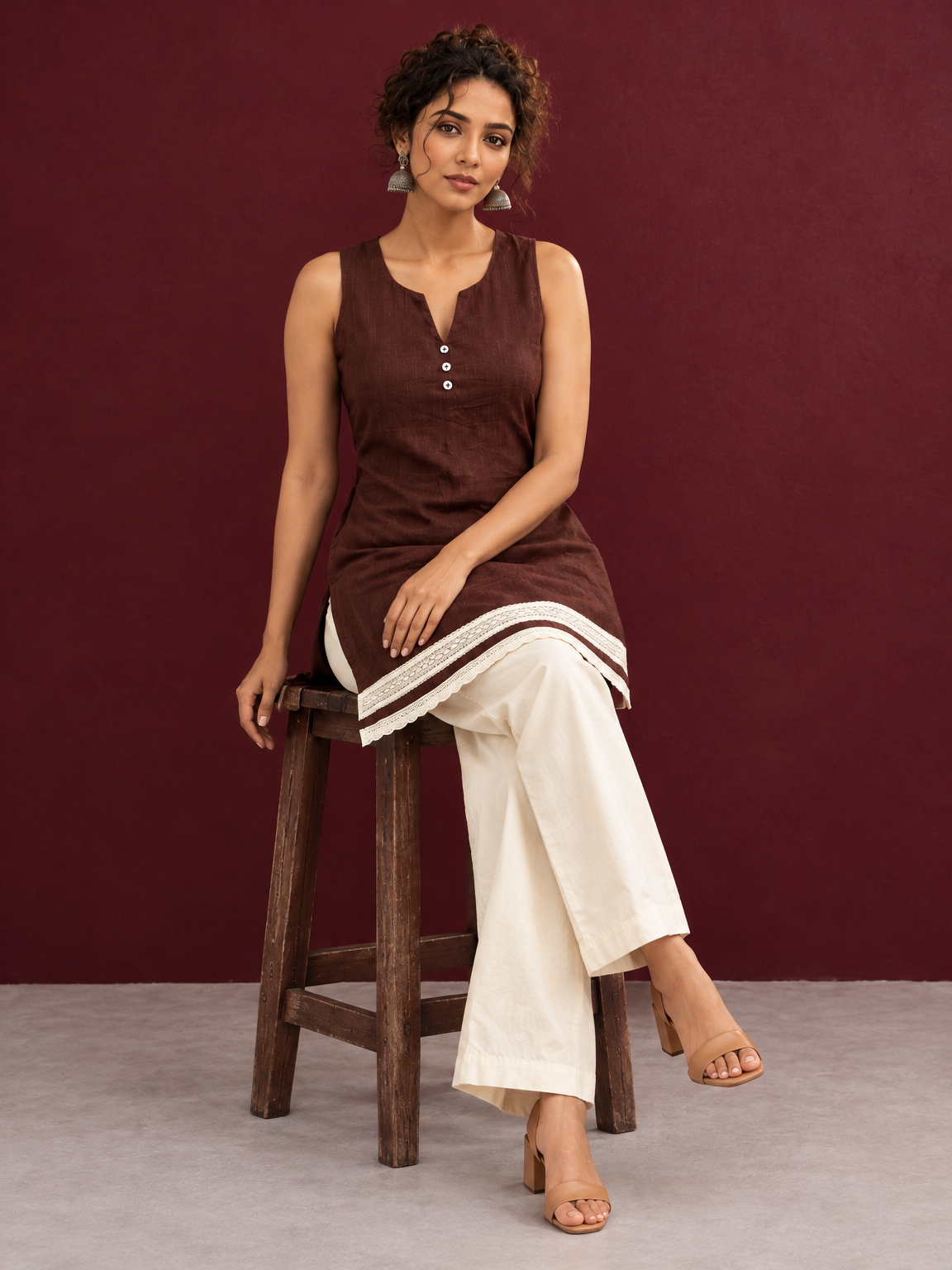 Timeless Brown Cotton Sleeveless Tunic with Notched V-Neck Button Placket & Contrast Lace Hem Border — seated