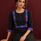 Timeless Black Cotton Kurta with Contrast Checkered Yoke Panel — seated detail