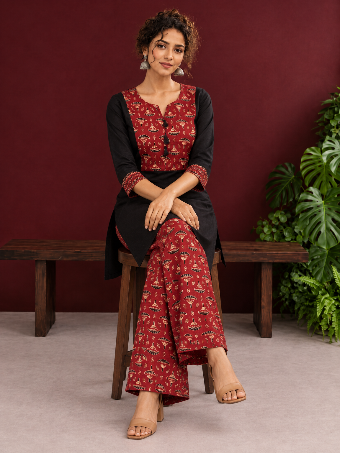 Classic Black Cotton Kurta with Maroon Ajrakh Print Yoke & Coordinated Sleeve Cuffs — seated