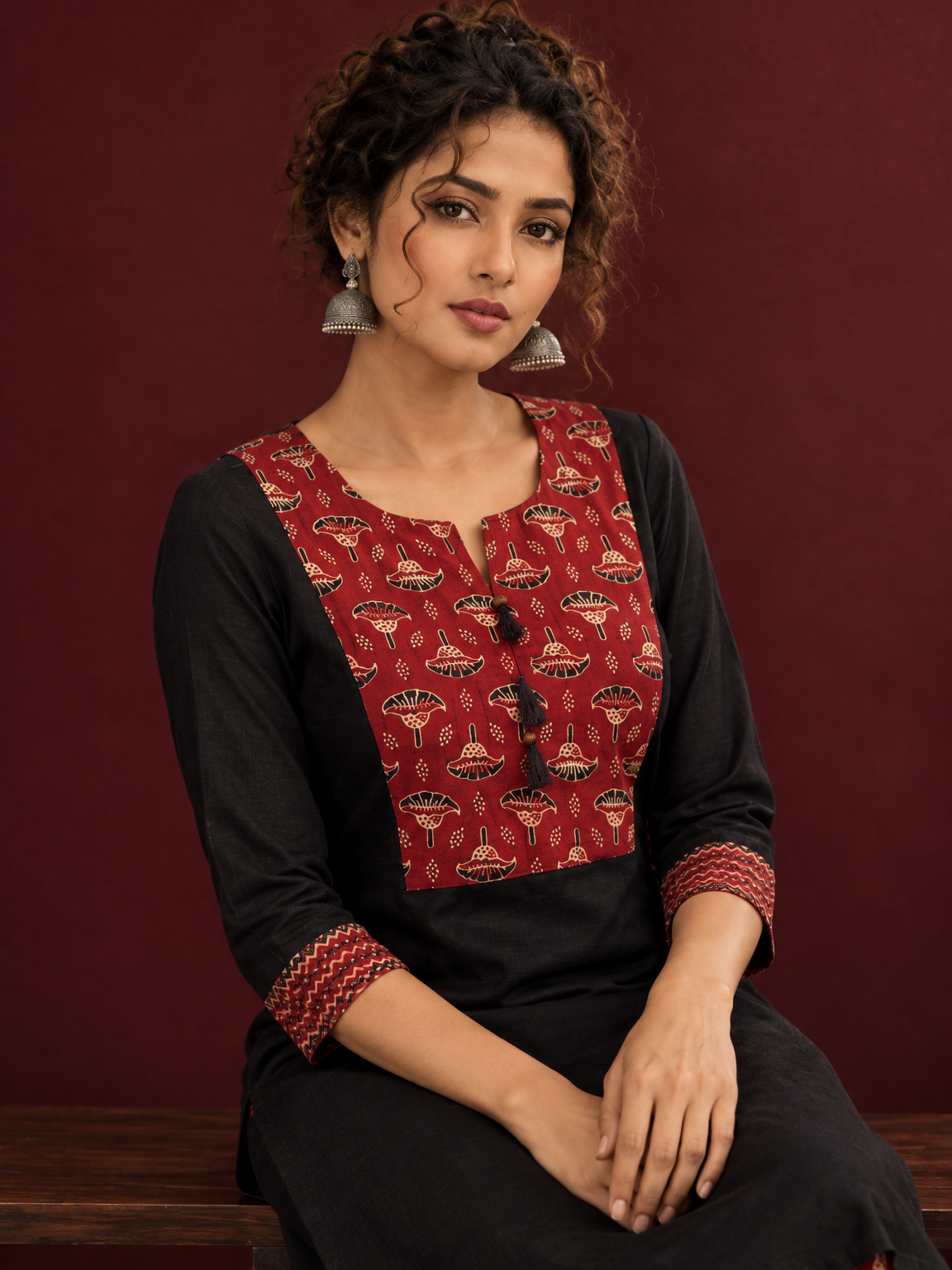 Classic Black Cotton Kurta with Maroon Ajrakh Print Yoke & Coordinated Sleeve Cuffs — seated detail