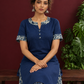 Navy Blue Cotton Kurta with Floral Printed Neckline and Sleeve Cuffs — seated detail