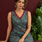 Teal Green Cotton Sleeveless Tunic with Floral Print, Maroon V-Neck Trim & Side Tie-Up Knots — seated detail