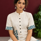 Classic Off-White Cotton Kurta with Contrast Geometric Print Pocket & Coordinated Sleeve Cuffs — seated detail