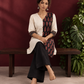 Timeless Off-White Cotton Tunic with Contrast Ajrakh Printed Leaf Panel & Coordinated Zigzag Sleeve Cuffs — seated