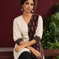 Timeless Off-White Cotton Tunic with Contrast Ajrakh Printed Leaf Panel & Coordinated Zigzag Sleeve Cuffs — seated detail