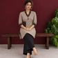 Elegant Beige Cotton Ajrakh Tunic with Contrast V-Neck & Cuff Detailing — seated