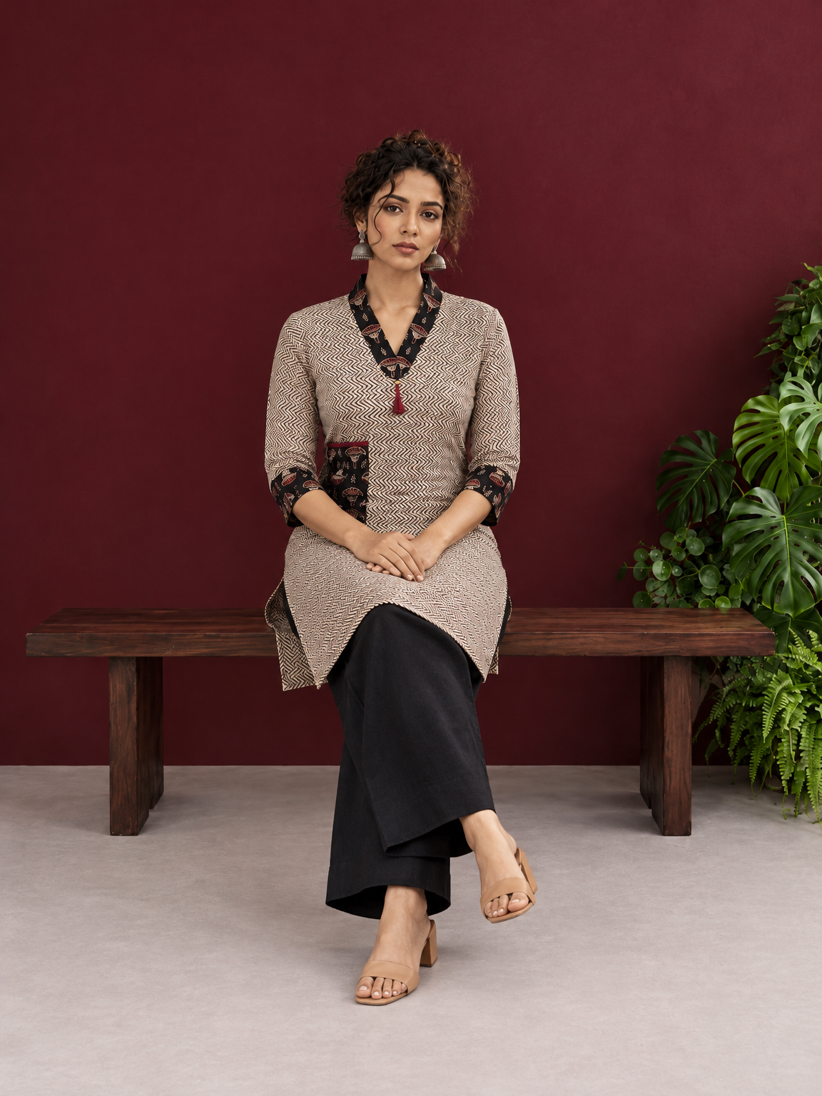 Elegant Beige Cotton Ajrakh Tunic with Contrast V-Neck & Cuff Detailing — seated