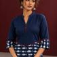 Navy Blue Cotton Tunic with Fish Print Hem Panel, Contrast Maroon Piping & Red Button Detail — fabric detail