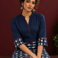 Navy Blue Cotton Tunic with Fish Print Hem Panel, Contrast Maroon Piping & Red Button Detail — seated detail