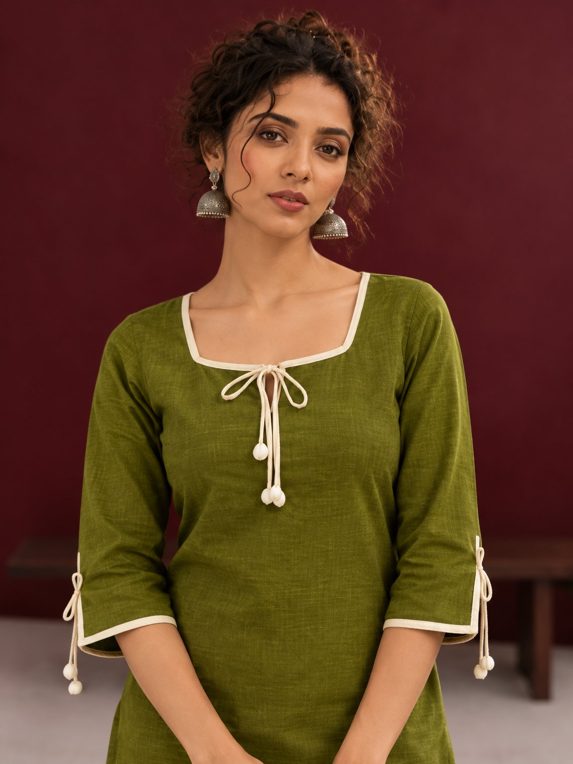 Timeless Olive Green Cotton Tunic with Tasseled Tie-Up Neckline and Contrast Lace Hem Border — fabric detail