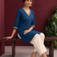 Elegant Teal Blue Cotton Tunic with Embellished Gold Lace V-Neckline and Matching Sleeve Cuffs — seated