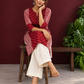 Maroon Rayon Tunic with Bandhani Dot Print Front Panel and Contrast Wavy Striped Sleeves & Side Panels — seated