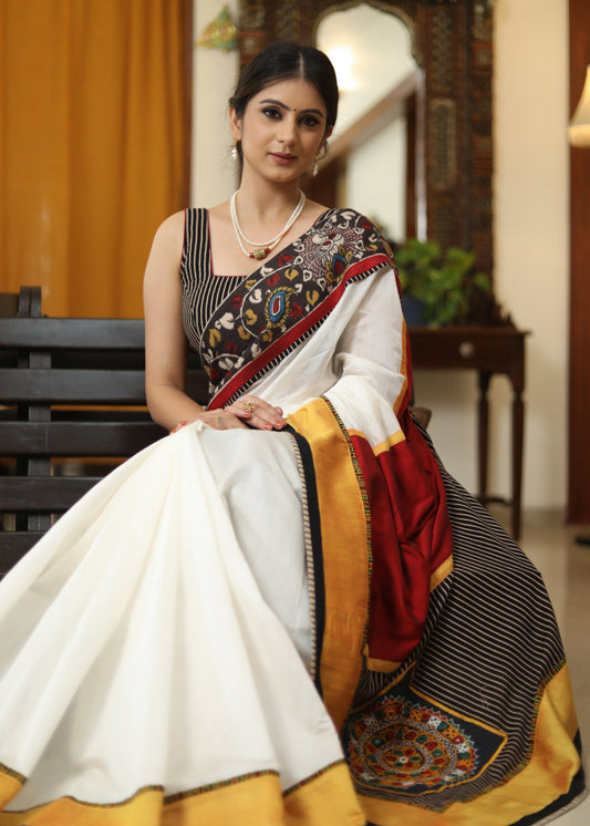 Smart white Chanderi saree with exclusive Kalamkari hand painted border and maroon Pallu with mirror work