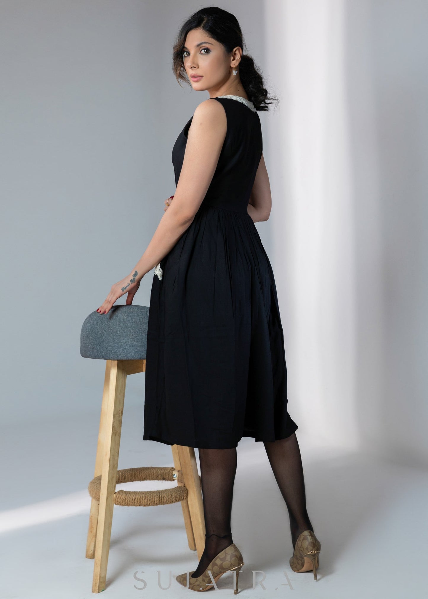 Black sleeveless rayon dress with off white lace detailing on neck and pockets
